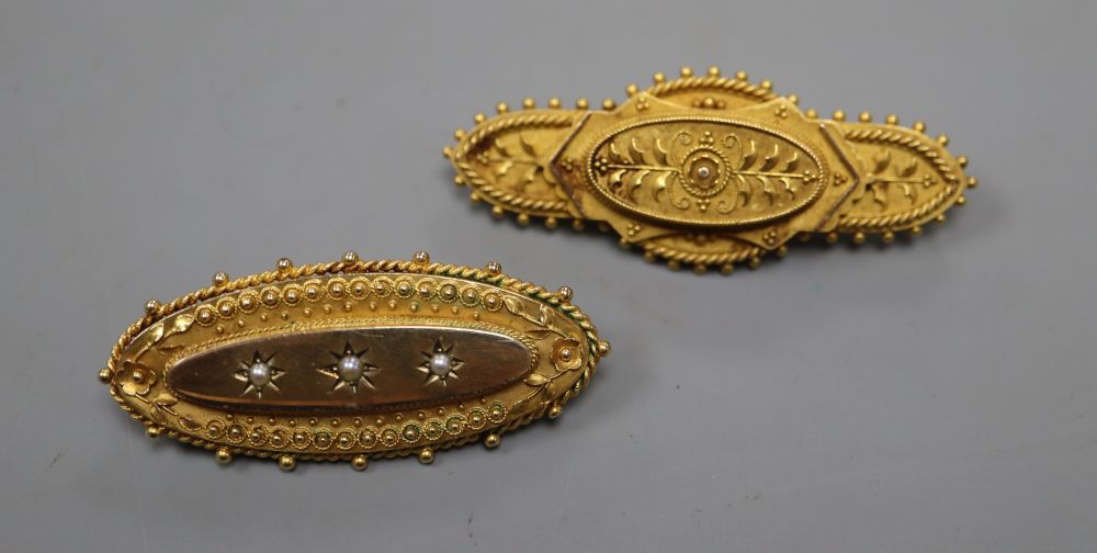 Two Victorian yellow metal oval brooches, with cannetile work decoration, one with seed pearls